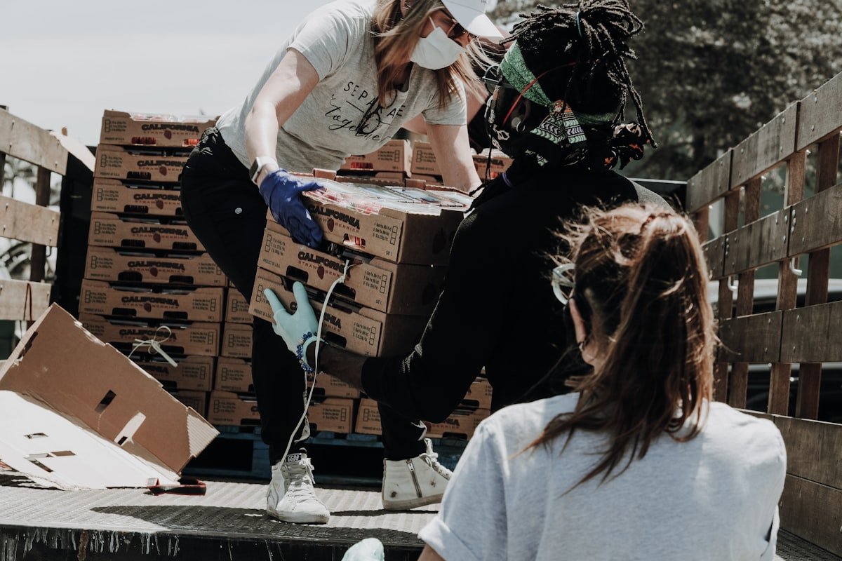 Volunteers working together to load and sort supply boxes
